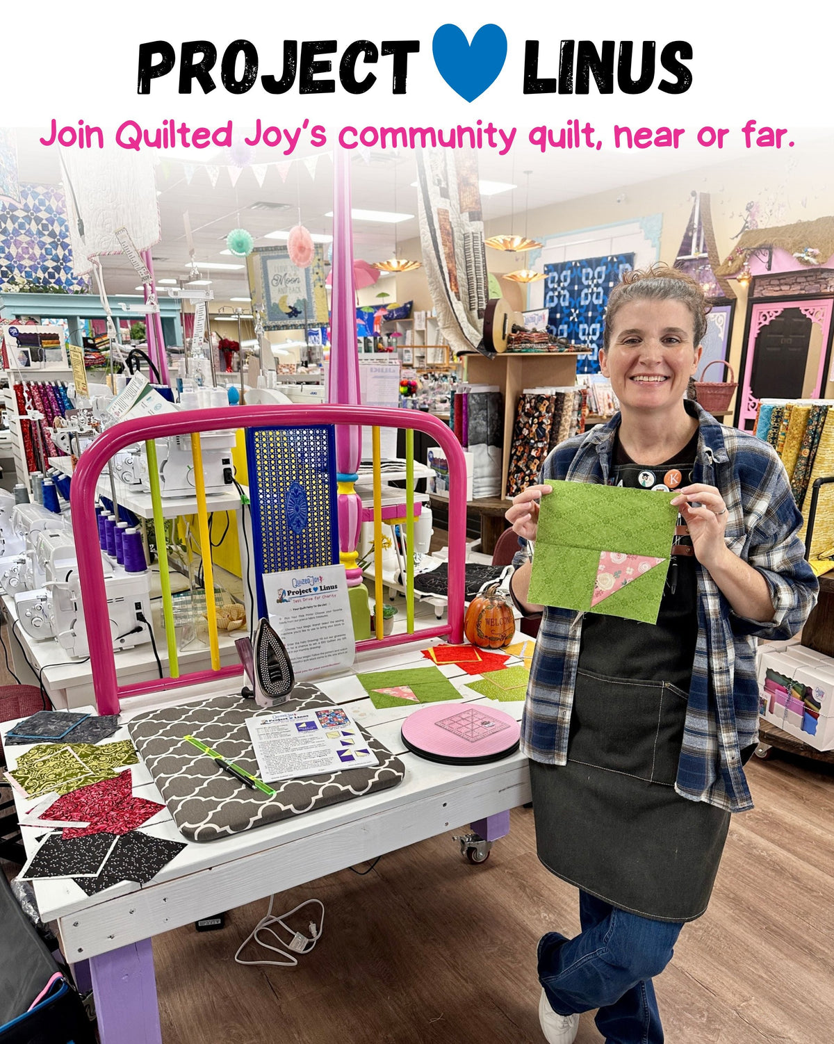 Woman in Quilted Joy store holding a quilt block for Project Linus community charity quilt