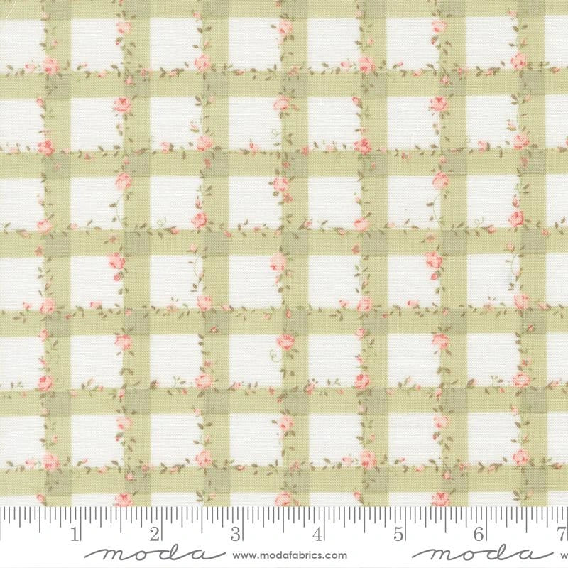 The Abide Light Green Plaid Gingham Fabric Yardage by United Notions features a white checkered pattern with pink floral vines; a ruler along the bottom shows inch measurements from 1 to 6.