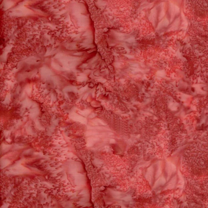 The 1895 Watercolors Barn Red Batik Fabric Yardage by Hoffman Fabrics features swirling pink and barn red patterns with a marbled, watercolor-like effect—soft and organic, ideal for inspiring unique quilting projects.