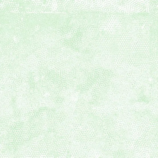 Dimples Mist Green Yardage by Andover features a light green background with a subtle, faded dimple and small hexagon texture, giving an abstract, fabric-inspired look.