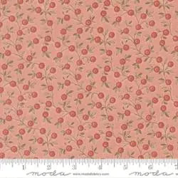 Fleur De Paris Pale Rose Floral Vines Fabric Yardage by United Notions features pink quilting cotton with small red roses and green stems, shown with a white ruler for scale—ideal for French General or Fleur De Paris projects.