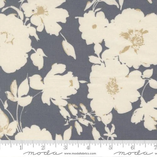 The Arabesque Dusk 108" Wide Quilt Backing Fabric by United Notions features a cream floral pattern on a muted gray-blue background, with large scattered flowers and leaves. A ruler along the bottom shows scale.