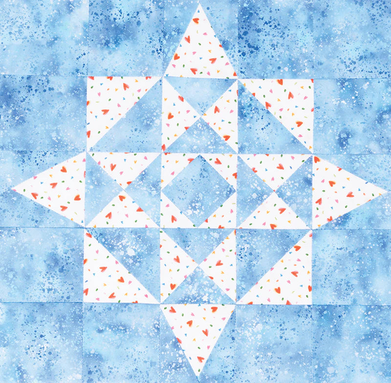 The Quick & Easy All Stars Block Tool by Brewer Sewing features a geometric star pattern with blue and white triangles. White areas have red, orange, and blue confetti shapes on a mottled blue background—perfect for star block inspiration.