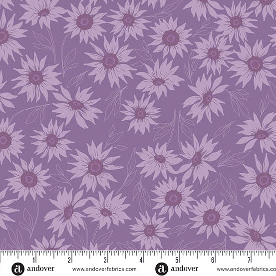 Color Me Whispered Periwinkle Marguerite Mist Fabric Yardage by Andover features light purple sunflowers and leaves on a periwinkle background, shown with an inch ruler for scale—ideal for quilting projects.