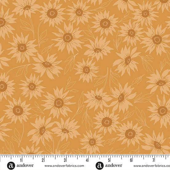 Andover’s Color Me Whispered Saffron Marguerite Mist Fabric features mustard yellow premium cotton with light tan sunflowers and leaves, shown with an inch ruler to display scale—perfect for quilting projects.