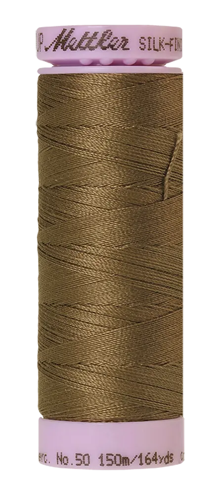 A spool of Mettler Cotton Silk Finish 50wt 150m Amygdala brown sewing thread with a pink plastic cap and base.