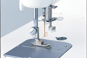 The automatic needle threader of the JUKI Haruka TL-18QVP engaged at the needle, with the thread looped through.