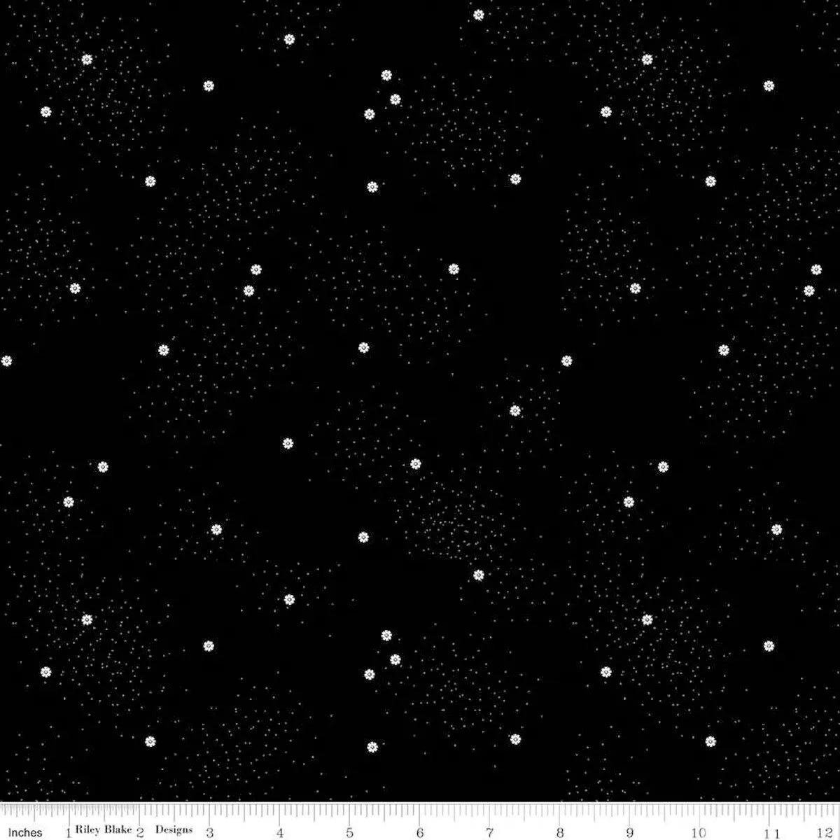 Dainty Daisy Licorice Fabric Yardage features black fabric with a pattern of small and large white dots. A ruler along the bottom edge shows inches to indicate the print’s scale.