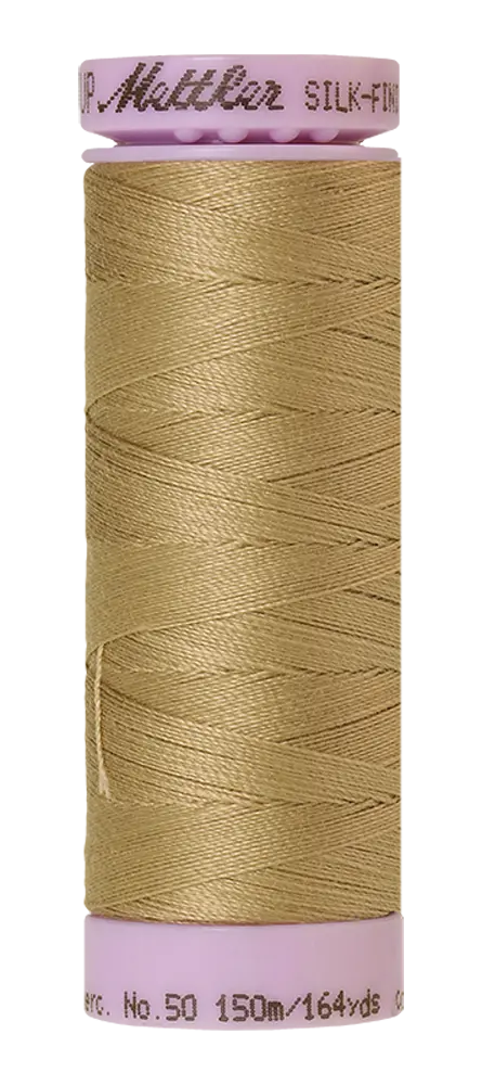 A spool of Mettler Cotton Silk Finish 50wt thread in Dark Rattan, 150m, is wound on a lavender reel labeled No. 50 and SILK-FINISH, featuring Mettler branding on the top.