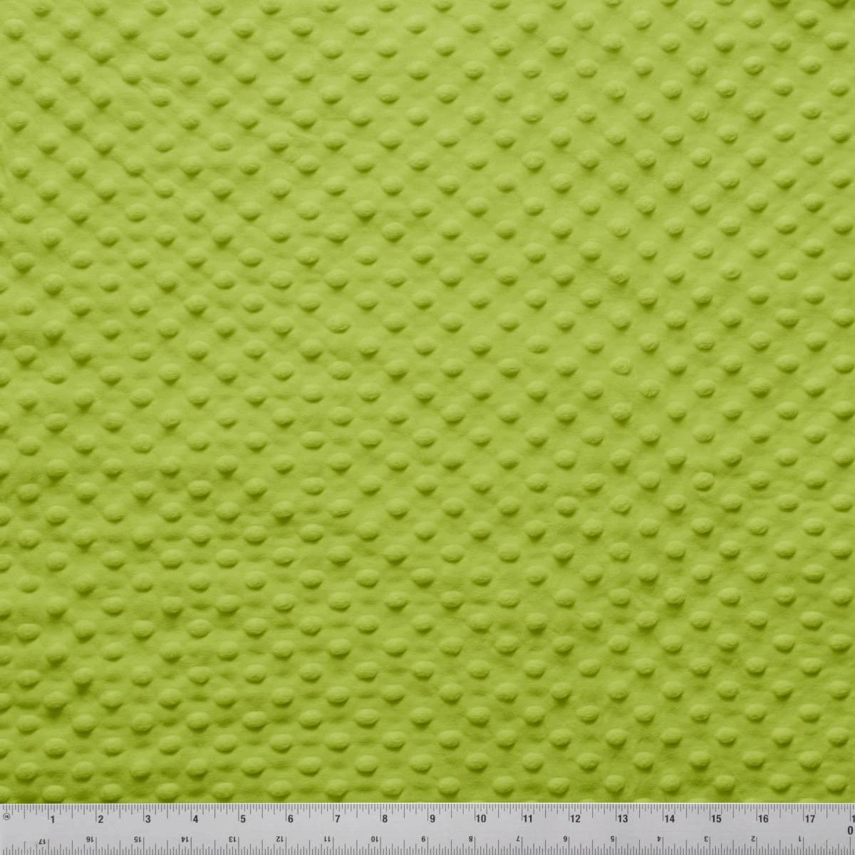 A close-up of Jaftex - Henry Glass Fabrics Minky Dots Apple Green 60" Wide Quilt Backing Fabric shows its raised dot texture, with a measuring ruler along the bottom edge for scale.