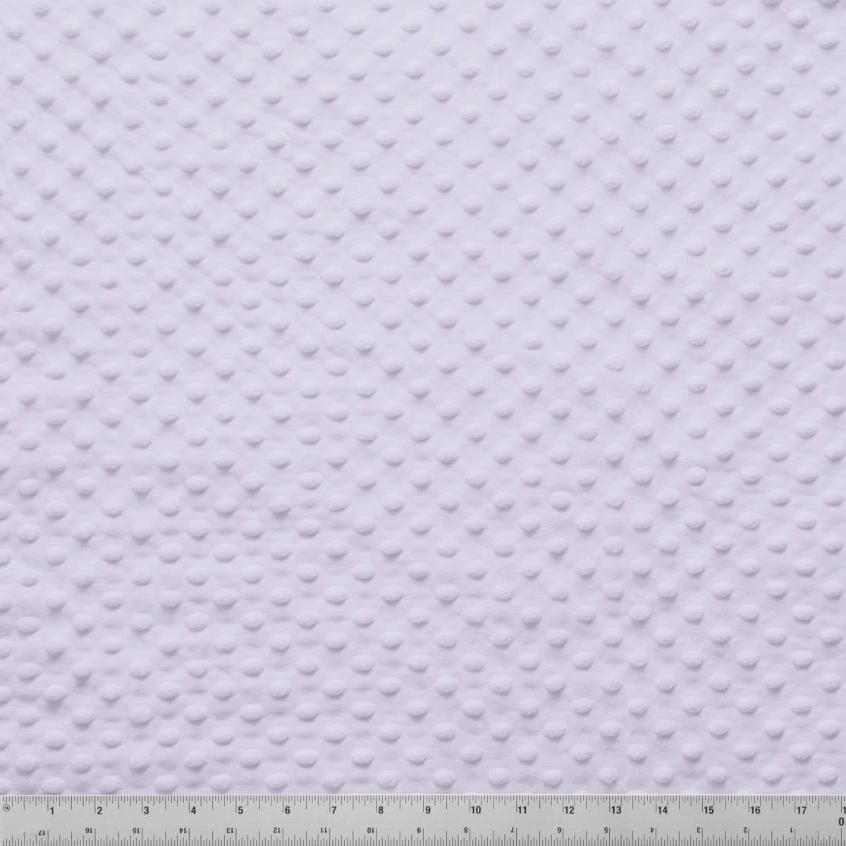 A close-up of Minky Dots Lavender 60" Wide Quilt Backing Fabric by Jaftex - Henry Glass Fabrics shows its raised dot texture with a ruler for scale, making it ideal for baby blankets.