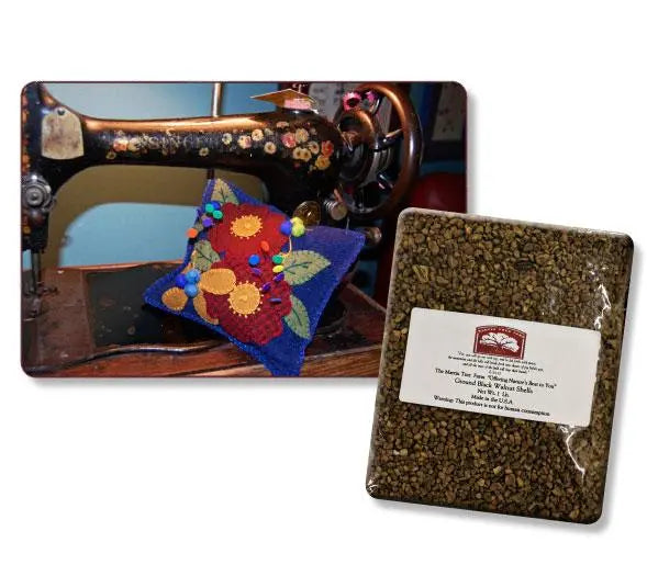 A vintage sewing machine with a floral pin cushion keeps pins sharp, resting beside a packet of whole buckwheat hulls and Ground Black Walnut Shells labeled for use as stuffing.