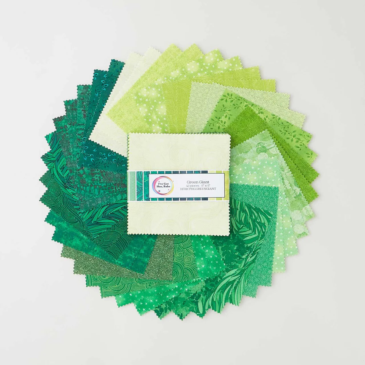 A circular display of Jaftex - Henry Glass Fabrics "I've Got Hue, Babe Green Giant 5" Squares" is fanned out around a labeled fabric bundle on a white background.