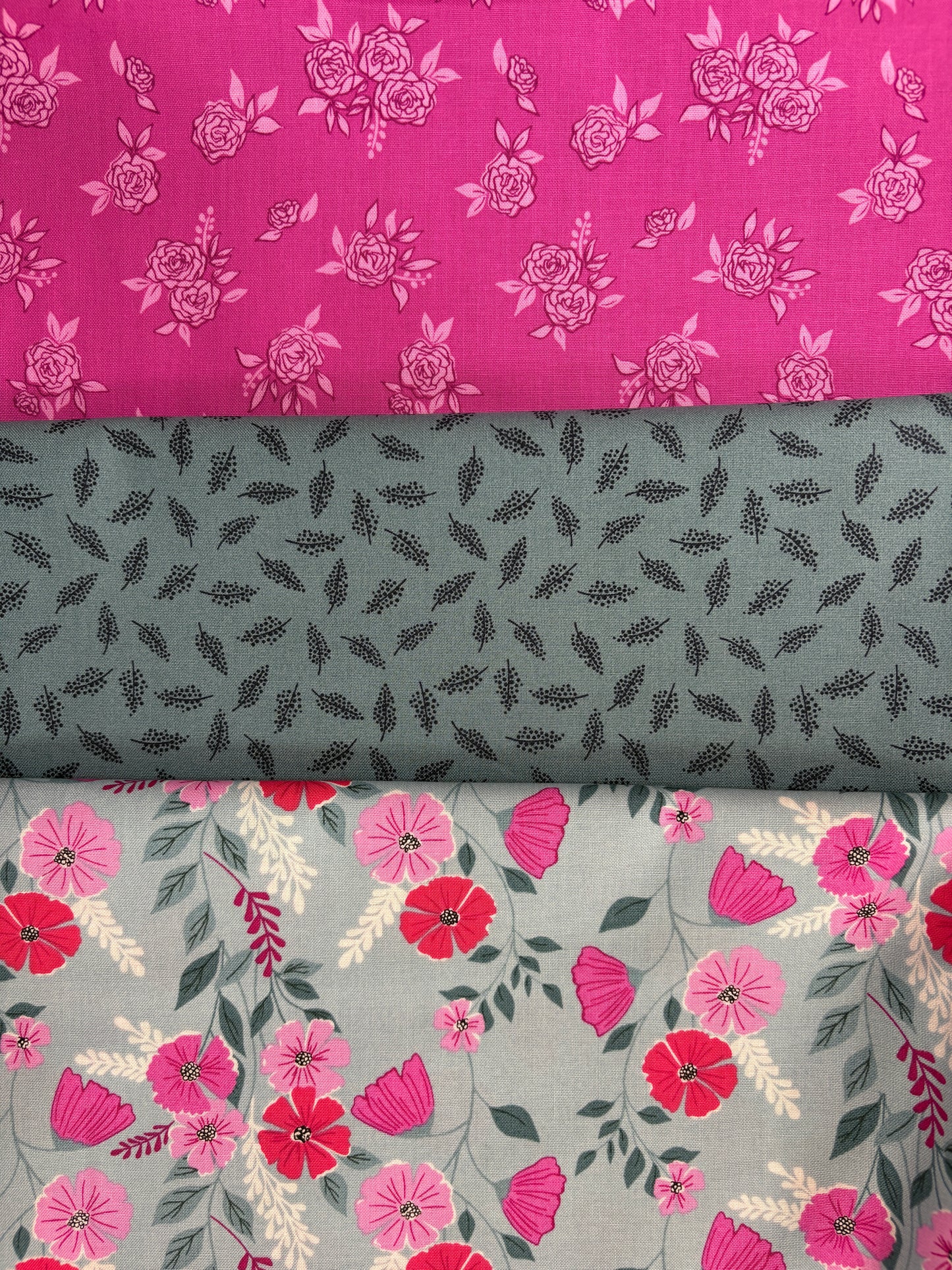 The Martha's Vineyard 3 Yard Quilt Top Bundle by Quilted Joy features pink rose-patterned, gray-green leaf, and gray floral cotton fabrics—perfect for Fabric Cafe quilt patterns or a coordinated quilt top.