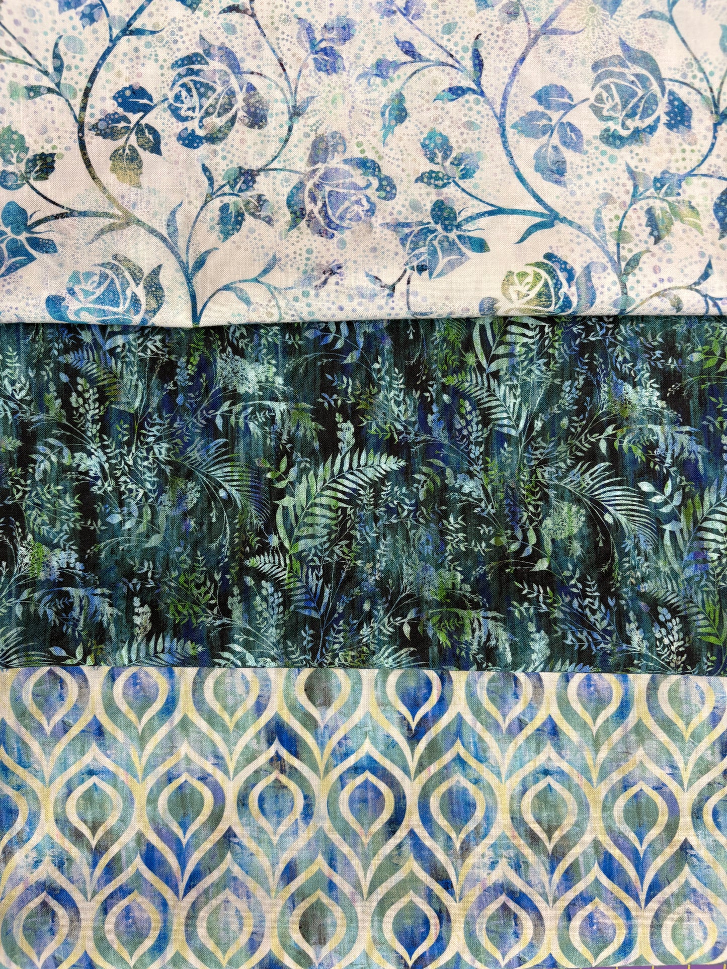The Quilted Joy Halcyon Blue Ferns 3 Yard Quilt Top Kit features blue roses and leaves, green ferns, and blue/gold teardrop fabrics—perfect for a 3-yard quilt or use with Fabric Cafe 3-yard quilt books.