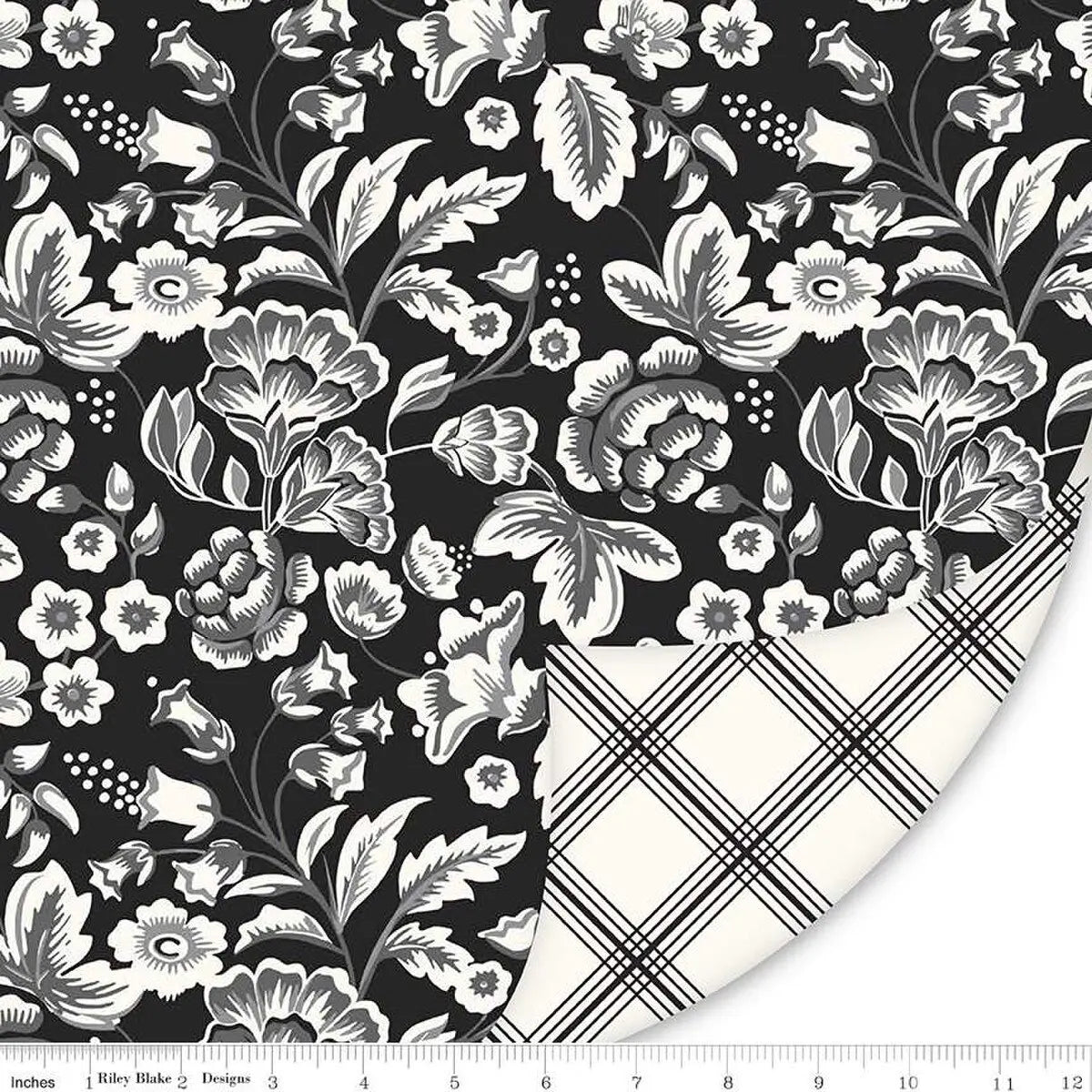 Midnight Meadow 58" Double Lush Velvet fabric features a black and white floral pattern with large flowers and leaves. The folded corner reveals a white underside with a black plaid design. A ruler along the bottom edge shows inches.