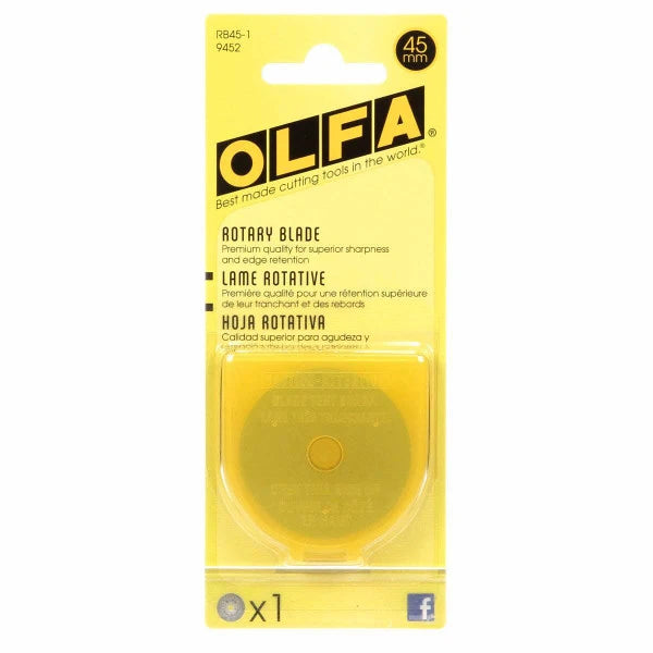 A yellow and clear plastic package holds the Olfa Rotary Replacement Blade - 45mm, made from premium tungsten tool steel, with multilingual text highlighting its superior sharpness and quality.