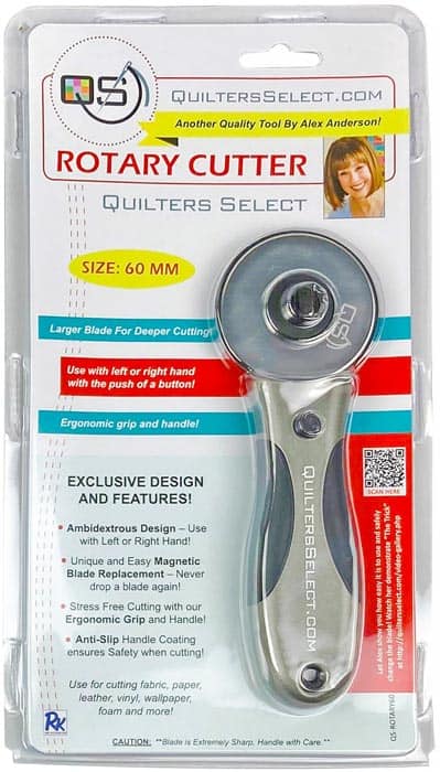 The RNK Distributing Quilters Select Deluxe 60MM Rotary Cutter features an ergonomic, ambidextrous handle, anti-slip grip, and magnetic blade replacement, all highlighted on the packaging for user convenience.