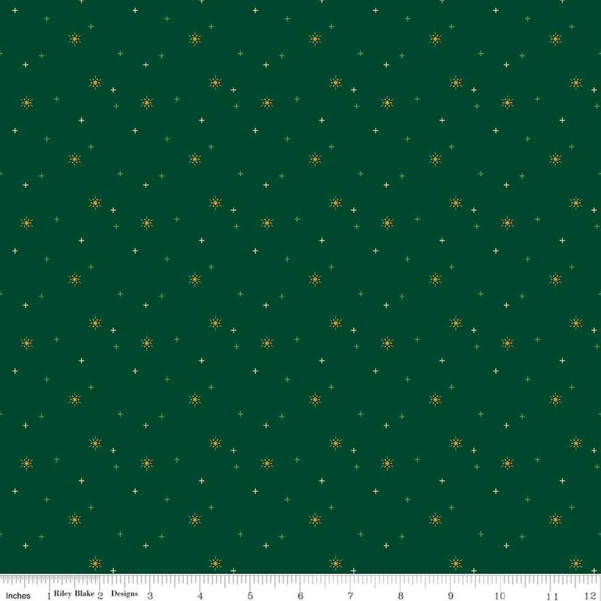 Sparkler Christmas Snowflake Fabric Yardage by Riley Blake features a green design with small yellow starbursts and tiny white plus signs. A ruler along the bottom edge shows inches 0 to 12.