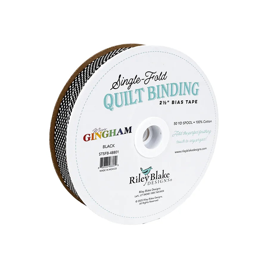 A 50-yard spool of Riley Blake Micro Gingham Black Single-Fold Quilt Binding, 2.5 inches wide, with product info on the white label.