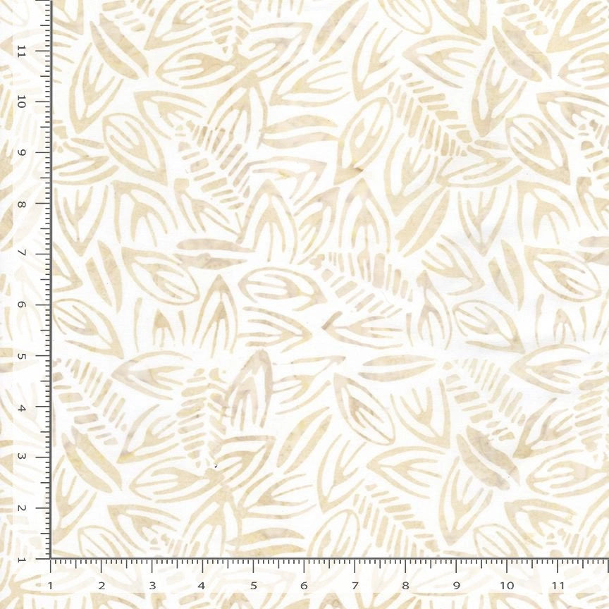 Tonga Coconut Tossed Leaves Batik Fabric Yardage features a cream-colored tropical batik with an abstract leaf pattern in beige tones. A ruler along the edges measures the fabric in inches to show the pattern’s scale.