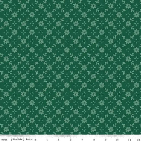 A Pear-fect Christmas True Love Green Fabric Yardage by Riley Blake features a repeating pattern of small, light green floral motifs—perfect for quilt backs or cotton sewing. Ruler along edge shows inches from 0 to 12.
