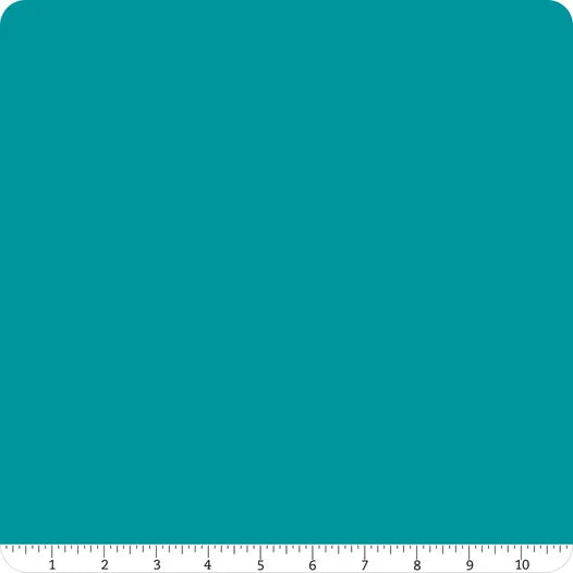 A square swatch of Riley Blake Confetti Cotton™ Paradise Solid fabric with rounded corners is shown. A white ruler runs along the bottom edge, marked 1 to 10 inches, to show scale. Ideal for quilting and cotton fabric projects.
