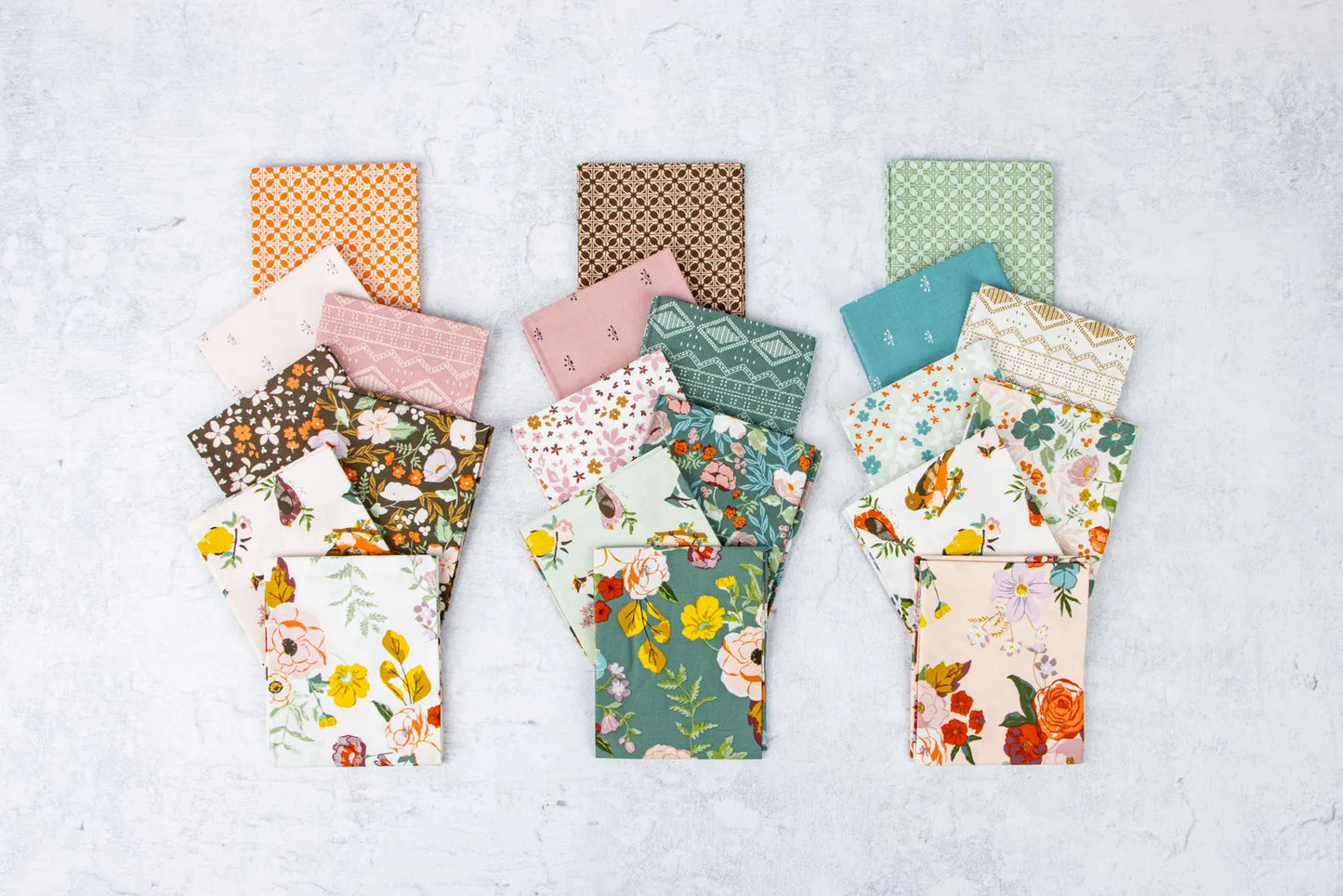 Collection of patterned fabric swatches on a light gray background