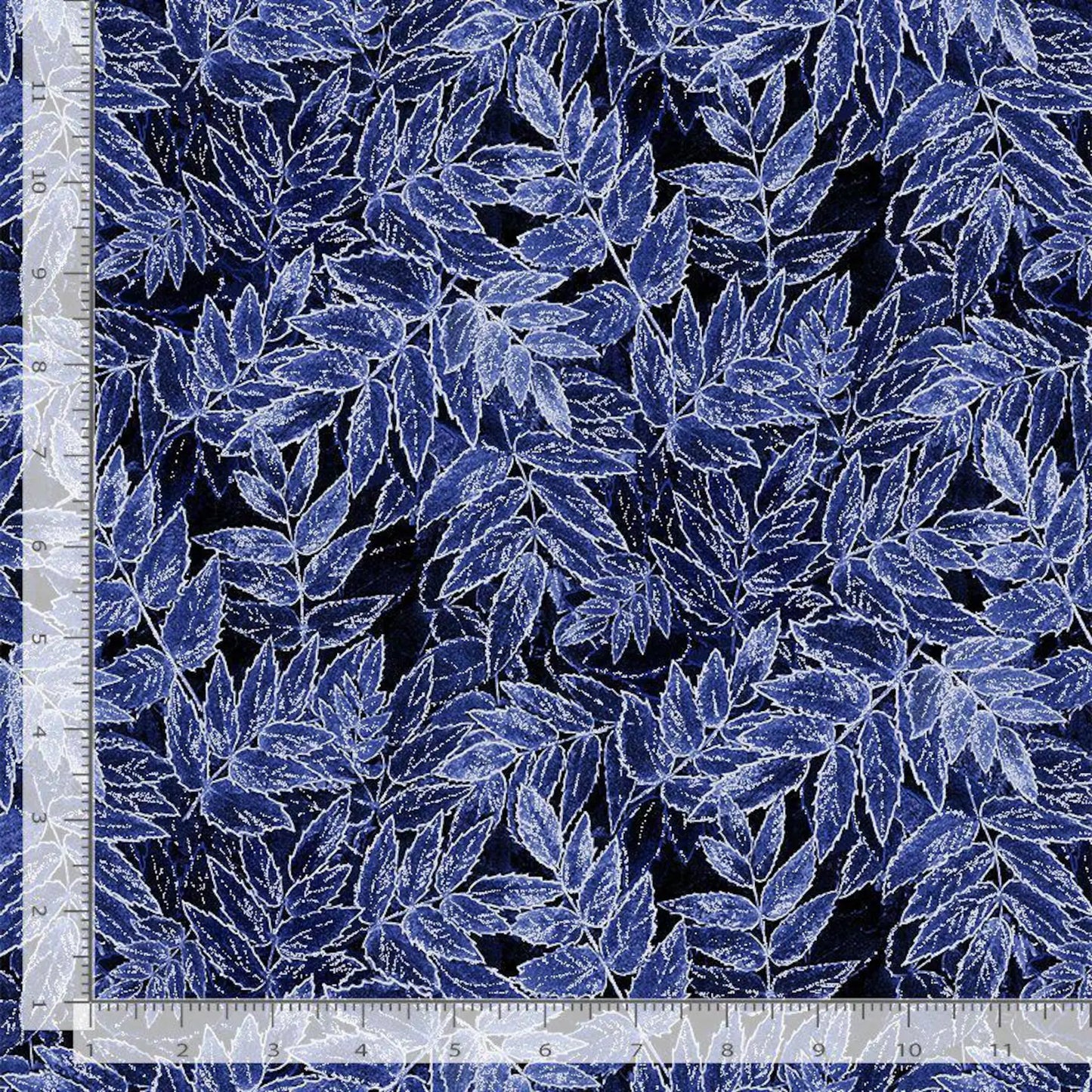 Timeless Treasures Ice Indigo Frosted Leaves Glitter Metallic Fabric Yardage features a dense blue and white outlined leaf pattern on a dark background, shown with an inch ruler along the left and bottom edges for measurement.