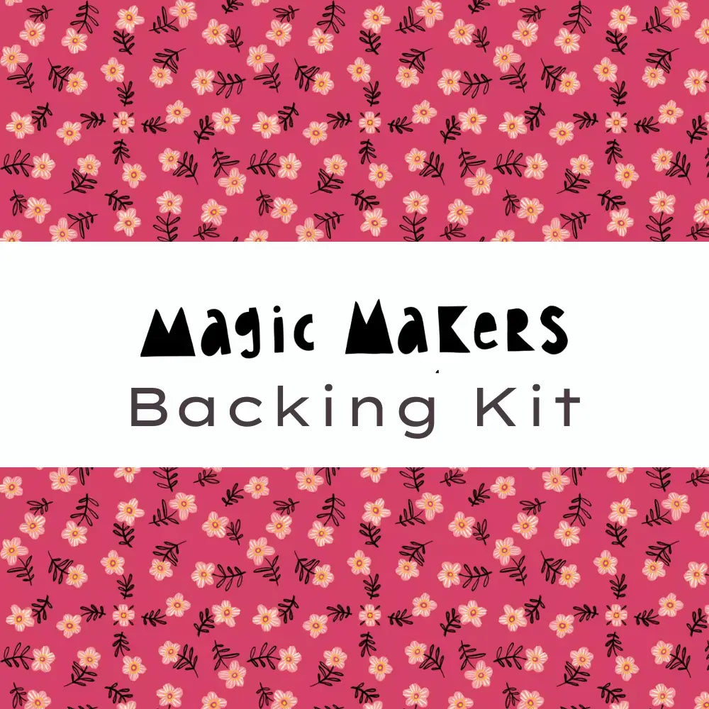 Text reads Magic Makers Quilt Kit Backing Kit on a white band across the center, featuring Cori Dantini’s Magic Makers Collection. The pink background shows a repeating pattern of small cream flowers and black leaves.