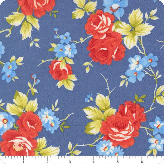 United Notions' Rosie Denim Jeans 108" Wide 3 Yard Quilt Fabric Back Pack features a blue background with red roses, small blue flowers, and light green leaves—ideal pre-cut backing for your quilt projects. A ruler shows its generous scale.