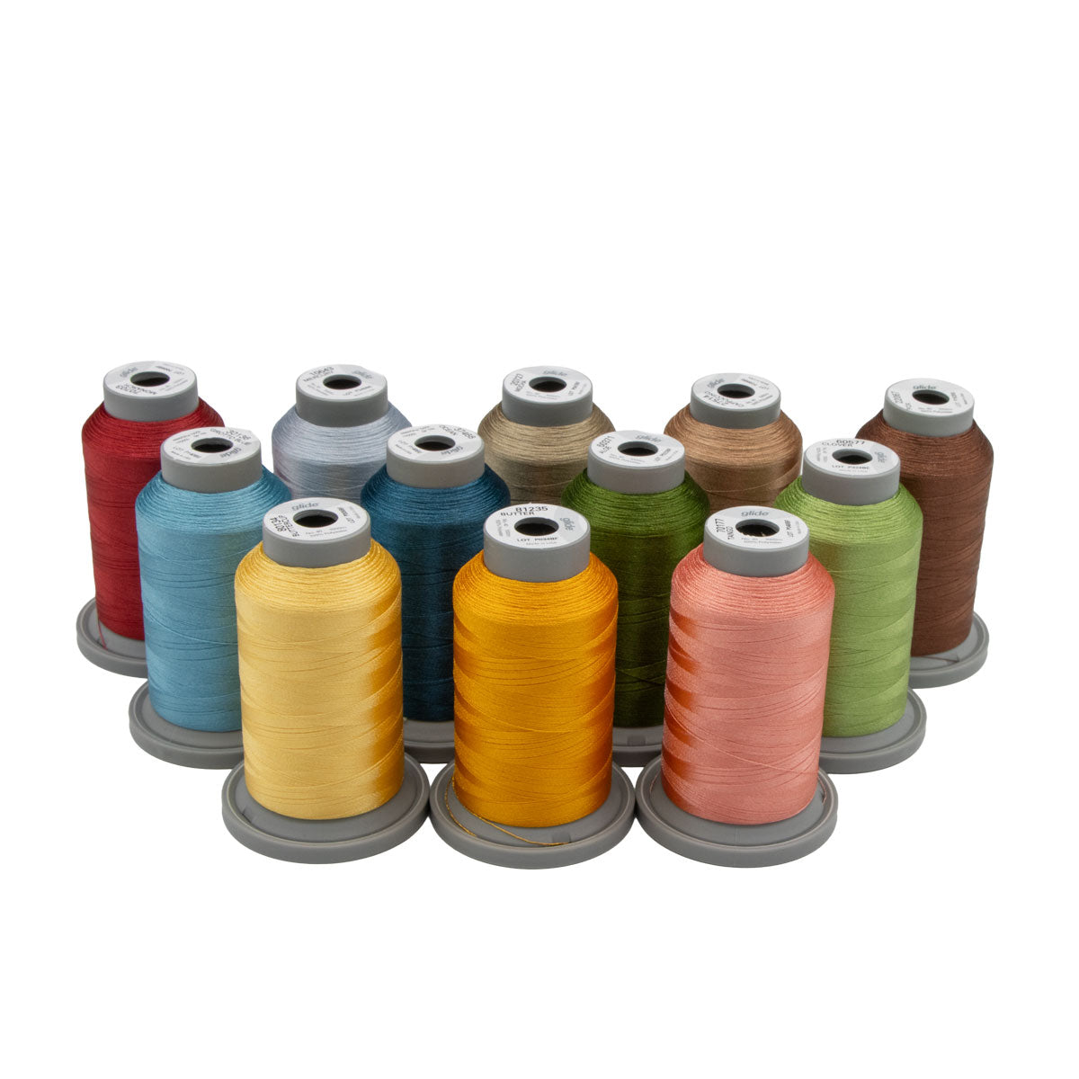 Twelve spools of Hab+Dash’s Kimberbell Sippin' On Sunshine Thread Bundle, featuring vibrant colors ideal for machine quilting, are arranged in three rows on a white background.