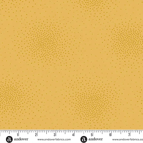 Spritz Canary Fabric Yardage by Andover features yellow tonal quilting fabric with scattered clusters of small darker yellow dots creating subtle texture. A ruler along the bottom measures inches 1 to 8.