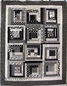 Karee made a black and white log cabin for her teenaged grand daughter. Quilter Angela Huffman added a fun all over Daisy pantograph. - QuiltedJoy.com