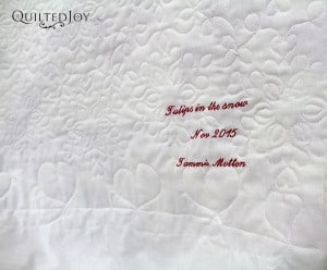 The snowflake design looks amazing on the back of Tammie's Tulips in the Snow quilt - QuiltedJoy.com