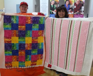 Renee and Sandy show off their finished quilts after their rental certification class - QuiltedJoy.com