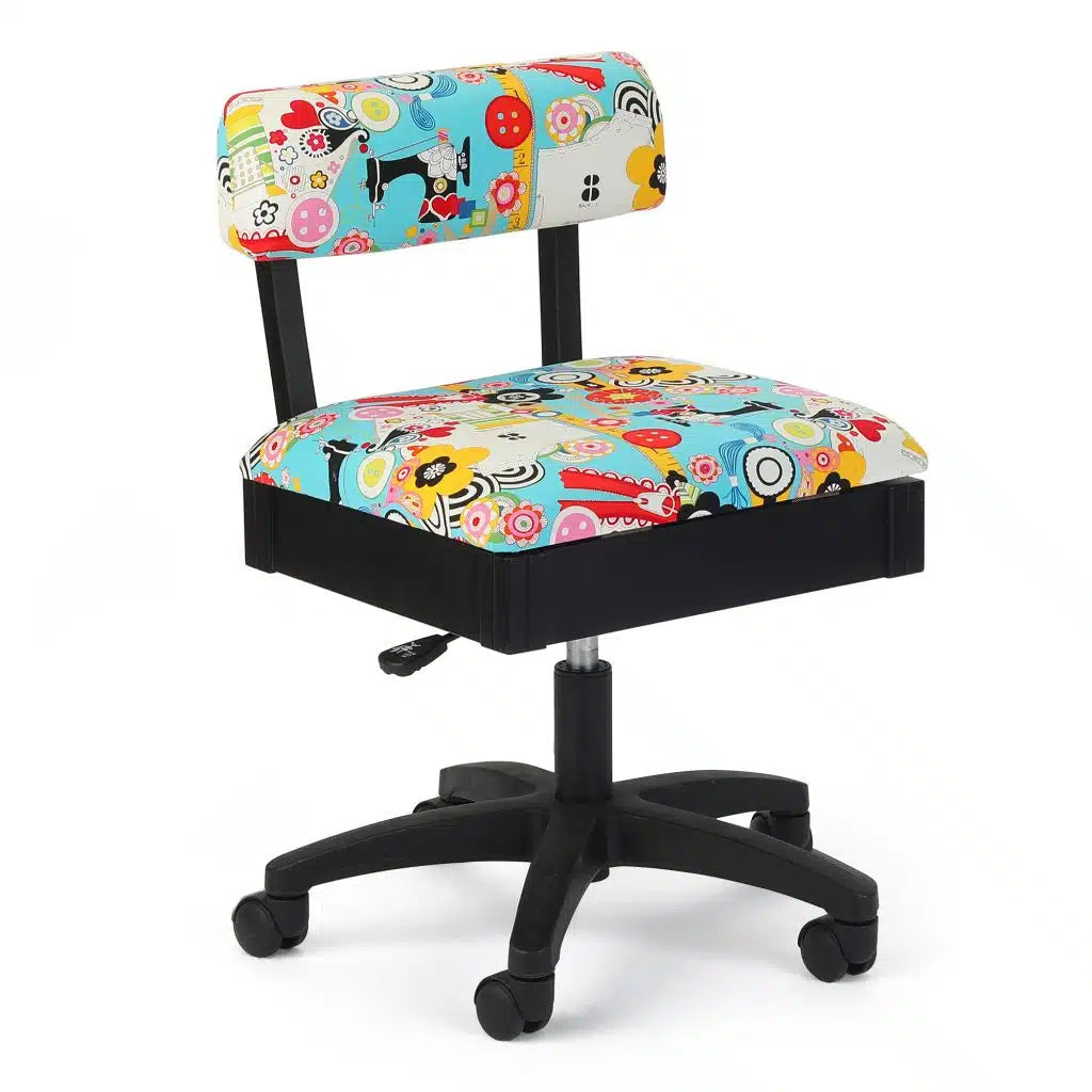 Colorful office chair with a black wheeled base, featuring a padded seat and backrest covered in a vibrant, multicolored fabric with playful patterns and cartoon designs.