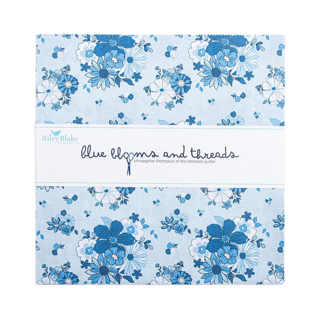 The Riley Blake Blue Blooms and Threads 10" Stacker features blue floral fabric squares, wrapped in a white paper band—ideal quilt precuts for your next creative project.