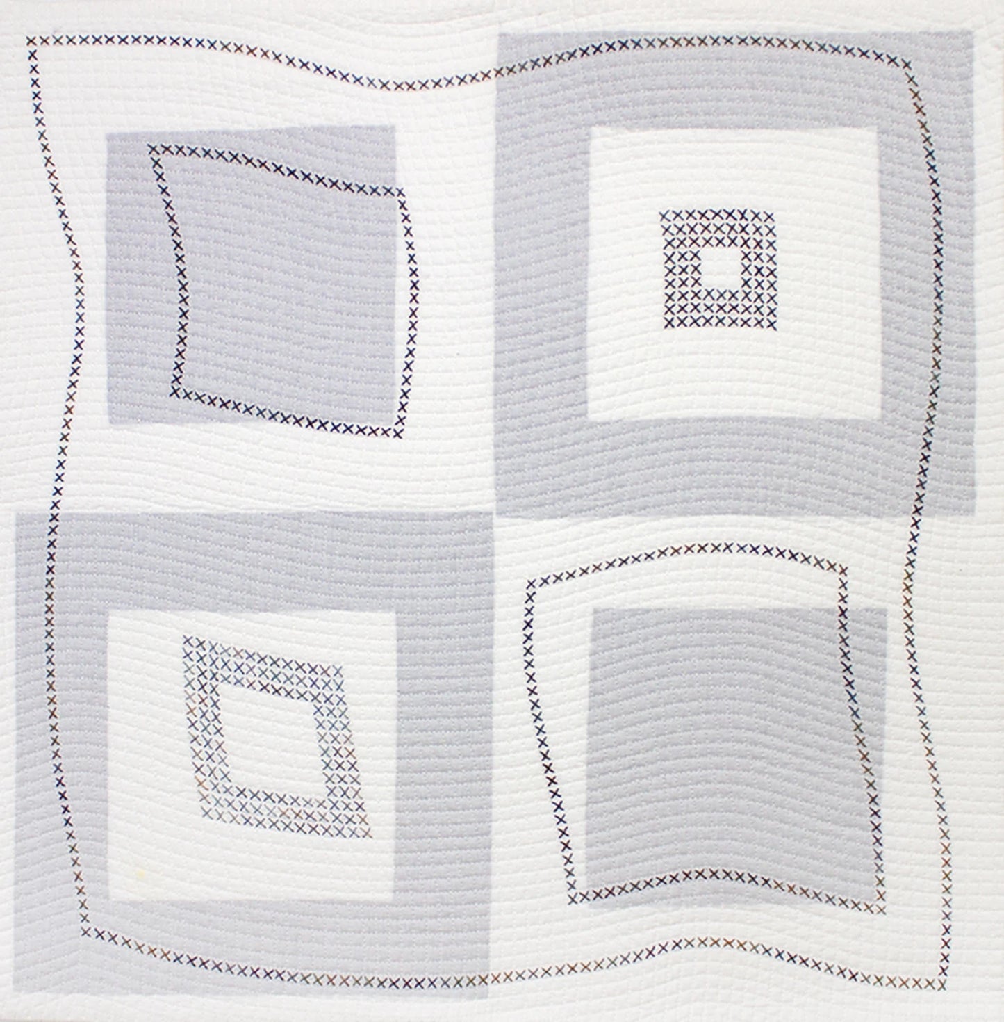 The Modern Machine Quilting Second Edition by Checker Distributor features a quilt with four large geometric squares, each filled with gray and white concentric blocks and decorative stitched X patterns, enhancing its slightly wavy design.