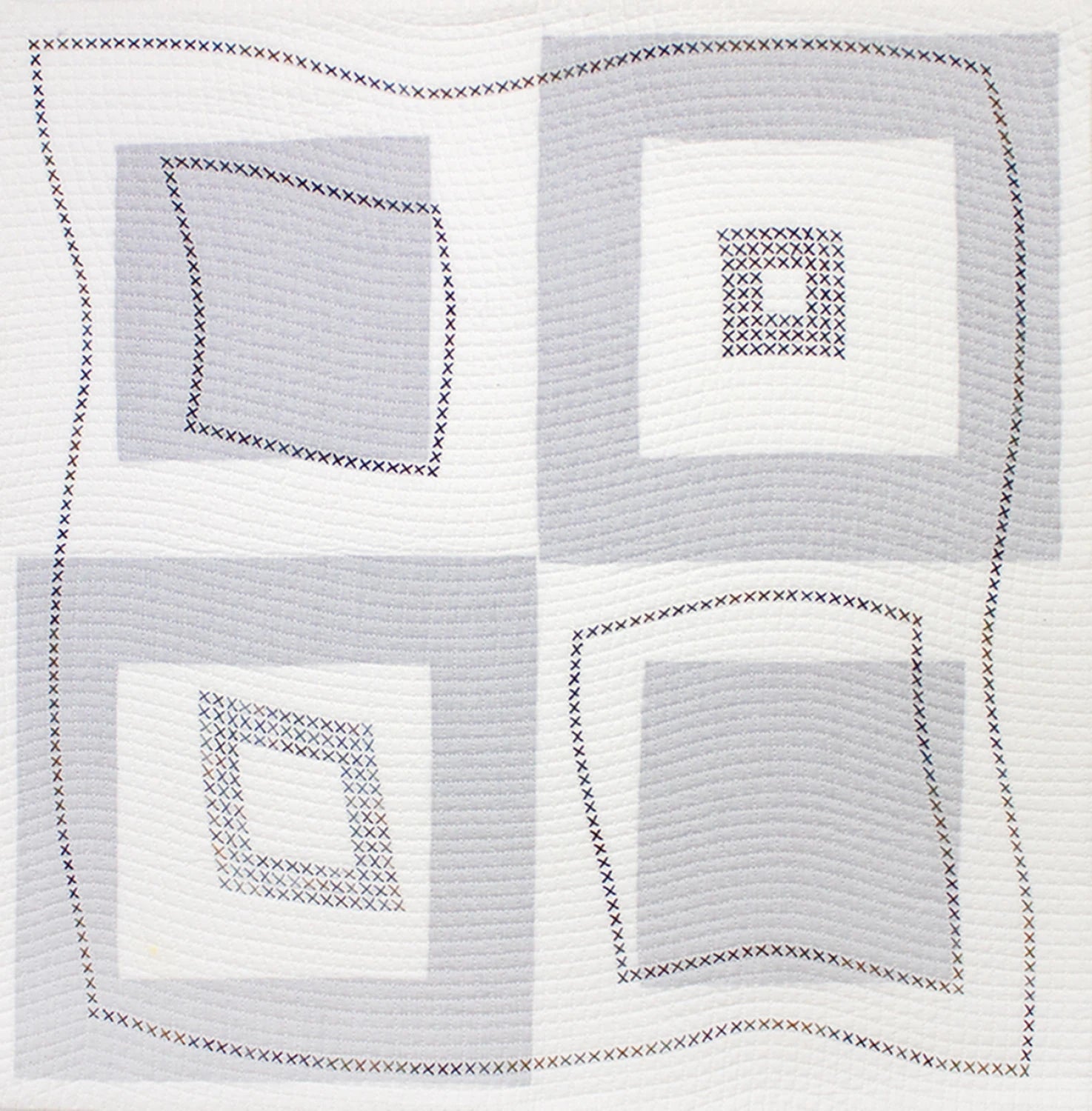 The Modern Machine Quilting Second Edition by Checker Distributor features a quilt with four large geometric squares, each filled with gray and white concentric blocks and decorative stitched X patterns, enhancing its slightly wavy design.