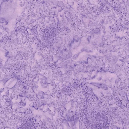 A close-up image of Sandstone Grape Fabric Yardage shows a textured surface with marbled, cloudy patterns and blended purple shades—perfect for highlighting the unique details of this distinctive fabric.