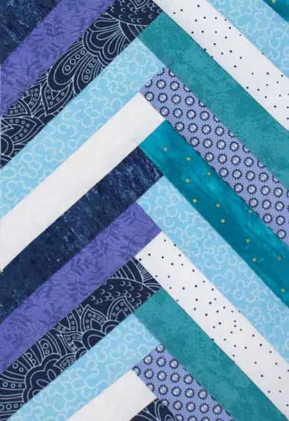 A quilt close-up shows diagonal strips in blue, teal, and white with floral, dot, and geometric patterns—made using the United Notions Braid Template for 1" to 3" strips.