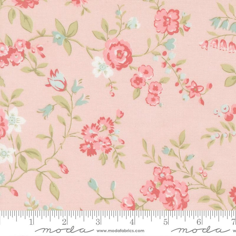 Abide Pink Main Fabric Yardage by United Notions showcases a delicate floral pattern in pink, white, blue, and green, featuring small flowers and leaves with a ruler and “moda” branding along the edge.
