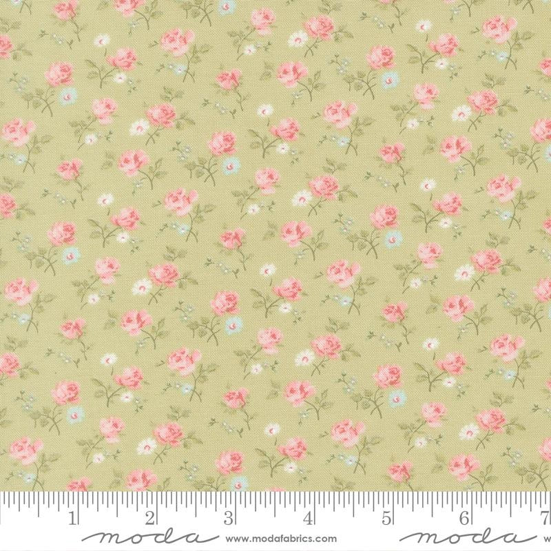 A fabric swatch of Abide Light Green Sprigs Fabric Yardage by United Notions, with a light olive-green background, pink roses, and green leaves. Ideal for quilting, shown with an inch ruler along the bottom edge.