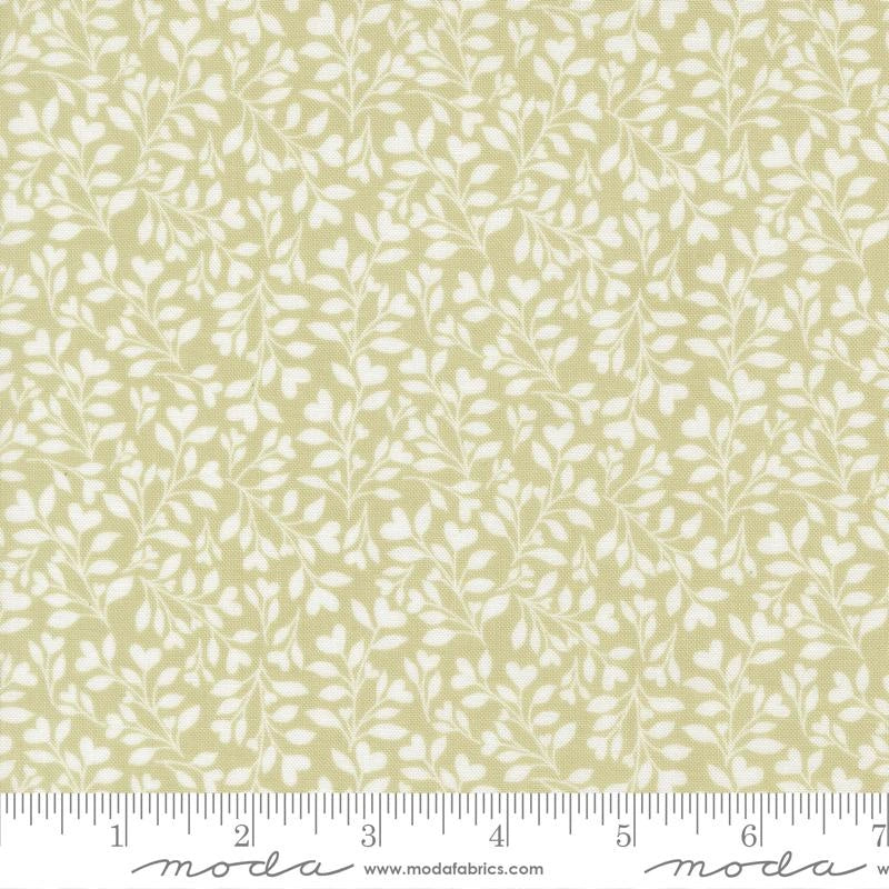 Abide Light Green Hearts and Leaves Fabric Yardage by United Notions features a light green botanical design with hearts and leaves, a ruler showing inches along the bottom edge, and the United Notions logo.
