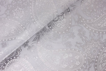 Close-up of Paisley with Silver Metallic Accents on Light Gray, displaying intricate floral and geometric designs. The softly folded fabric highlights the detailed metallic print and elegant shimmer.