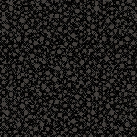 Quilting Illusions Black Bubbles Fabric Yardage by QT Fabrics features a seamless pattern of dark grey circles on black, perfect for quilting projects and creating an abstract polka dot effect.