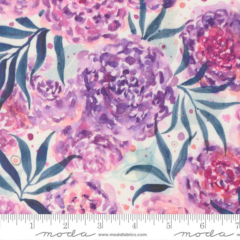 United Notions' Soulstice Dhalia Mama Lavender Fabric Yardage features watercolor-style purple and pink peonies, green leaves, and dots on a soft pale background—perfect as lavender quilting fabric. Ruler at the edge shows inches for scale.