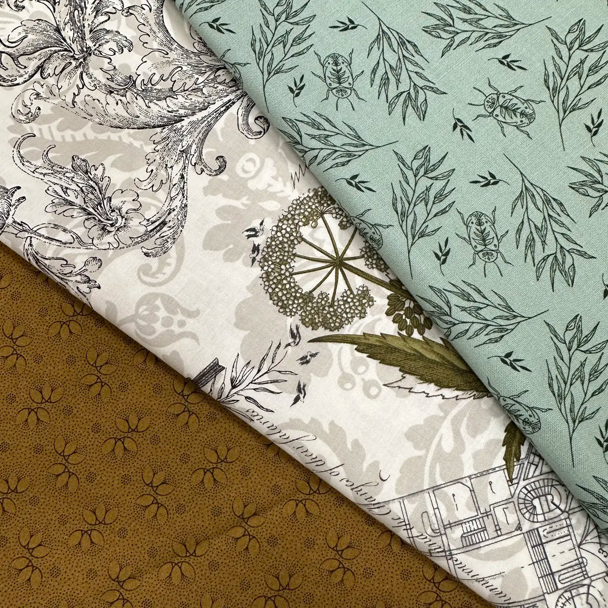 The Quilted Joy 3 Sisters Fav 3 Yard Quilt Top Bundle includes three cotton fabrics—brown florals, white botanicals and architecture, and teal with insects and leaves—ideal for projects inspired by Fabric Cafe quilt books.