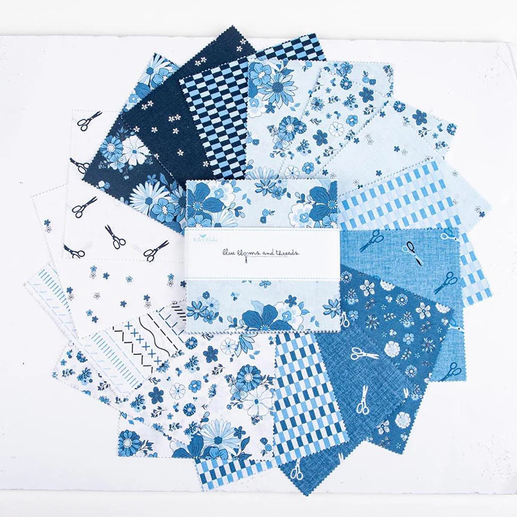 A circular display of Riley Blake’s Blue Blooms and Threads 5" Stacker features blue and white squares with floral, checkered, striped, and scissor prints. The label in the center highlights its charm pack for quilting precuts.